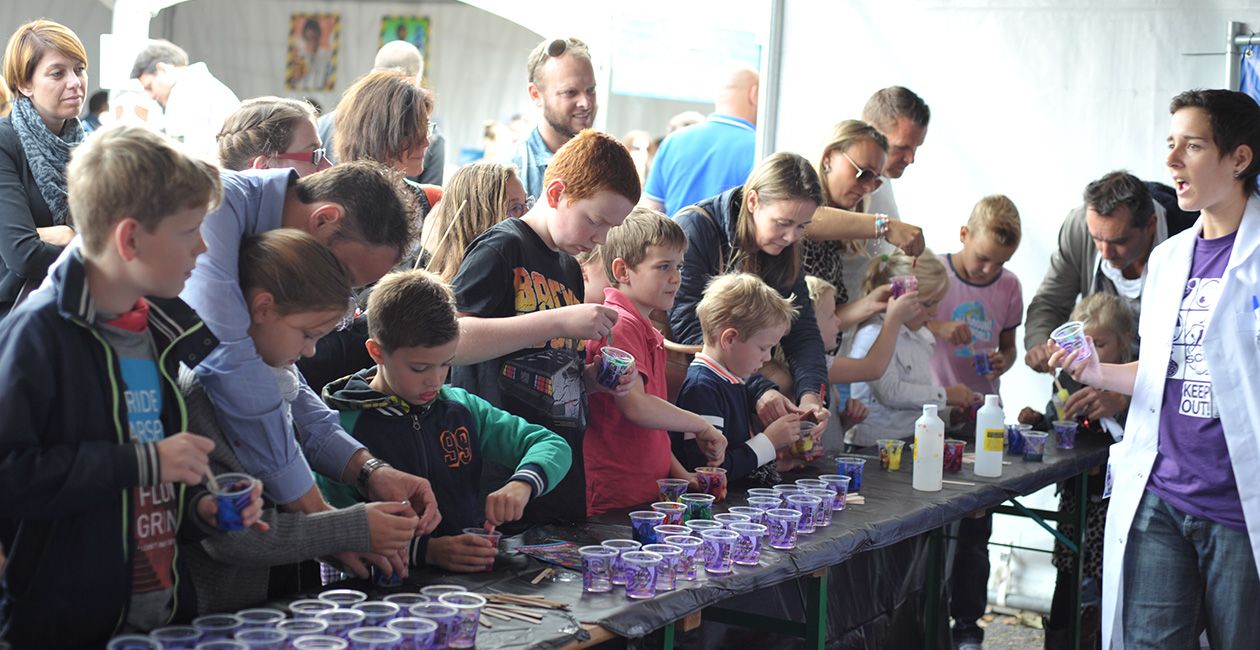 Kids at a table making slime in a cup
