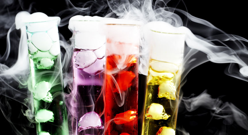 4 test tubes one red, one yellow, one green and one purple with dry ice inside.  
